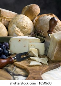 An assortment of breads and cheeses on a table