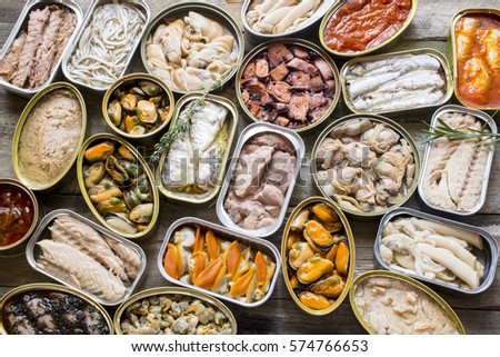 Assortment of cans of canned with different types of fish and seafood,