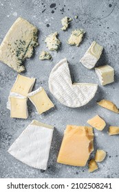 Assortment of cheese. Camembert, brie, blue cheese, parmesan. Gray background. Top view