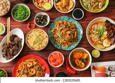 Assortment Of Chinese Food On Wooden Table