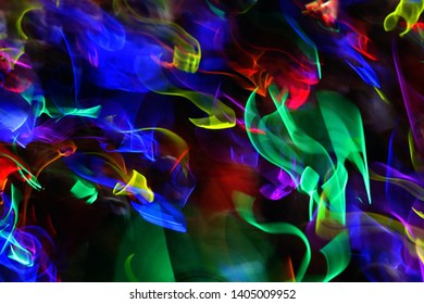 An assortment of colored light streaks against a black background.