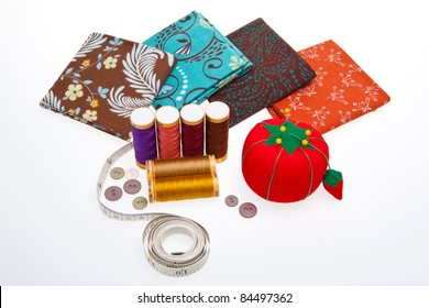Assortment Of Colorful Fabrics And Sewing Tools For Quilting.