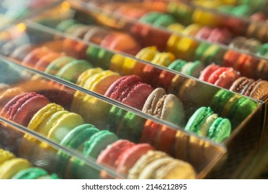 Assortment Of Colorful French Macaroons On Cafe Showcase For Sale . Variety Of Macaron Flavours. Sweet Almond Cakes In Store. Cookies In The Shop On Storefront