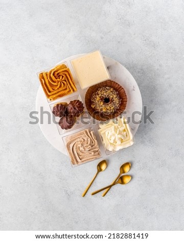 Assortment of confectionery, different types of cakes and desserts on the table.