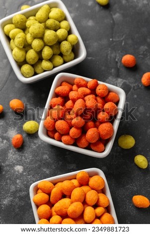Assortment of crunchy peanuts snack. Green wasabi, Red spicy chilli, yellow jalapeno cheese