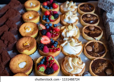 Assortment of delicious and colorful dessert, chocolate cake, mixed berry tart, Lemon Meringue Tart, chocolate tart made by pastry chef. All look tasty and delightful. Perfect for party. Natural light - Shutterstock ID 1151488724