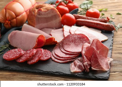 Assortment of delicious deli meats on slate plate