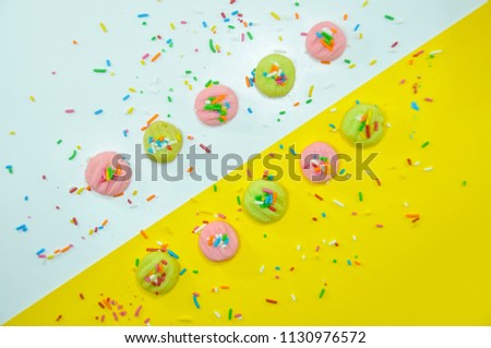 Assortment of desserts. Sweets, cake and others isolated on yellowwhite background. Image on top view. Food concept.