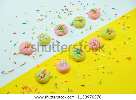 Assortment of desserts. Sweets, cake and others isolated on yellowwhite background. Image on top view. Food concept.
