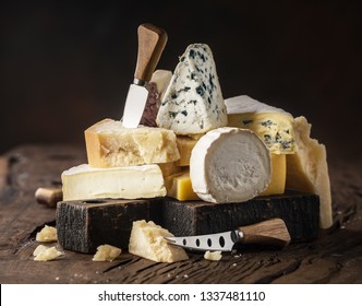 Assortment of different cheese types on wooden background. Cheese background. - Powered by Shutterstock