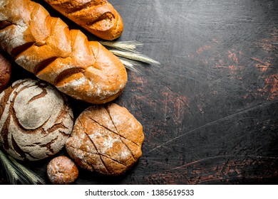 Assortment of different types of bread. On rustic background - Shutterstock ID 1385619533