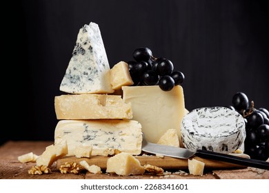 Assortment of different types of organic cheeses on a wooden table. Cheese background. - Powered by Shutterstock