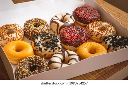 Assortment of donuts of different flavors in a box.  - Powered by Shutterstock