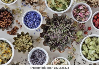Assortment of dried herbs: blossom, root and seed, flat on the table, lavender, chamomile, lime, rose, cornflower, meadowsweet, thyme and others overhead top view, naturopathy and medicine concept - Shutterstock ID 1891525303