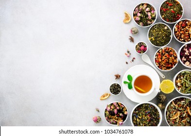 Assortment of dry tea in white bowls. Tea types backgound: green, black, floral, herbal, mint, melissa, ginger, apple, rose, lime tree, fruits, orange, hibiscus, raspberry, cornflower, cranberry. - Powered by Shutterstock