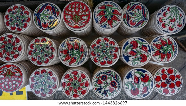 Assortment of floral red tulips pattern\
trivets coaster sold on a street of Istanbul,\
Turkey.