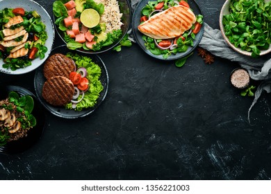 Assortment Of Food. Folk Cuisine On A Black Wooden Background Top View. Free Space For Your Text. Flat Lay