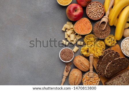 Assortment of food rich on fiber and carbohydrates on gray background with copy space