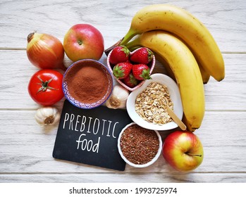 Assortment of foods high in prebiotics for healthy gut and digestive system. Prebiotics rich foods to aid digestion and gut health. Natural food sources of prebiotics for good gut bacteria.