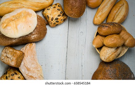 Assortment of fresh baked bread on wooden rustic table background