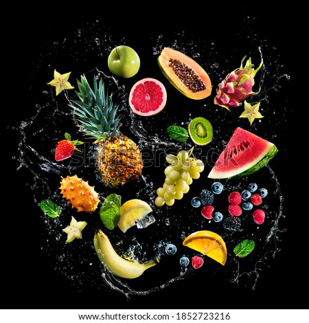 Assortment of fresh fruits and water splashes on black background. High resolution collage for print