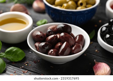 Assortment of fresh green, kalamata and black olives in bowl. Healthy snack - Powered by Shutterstock