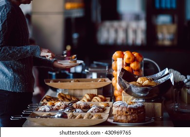 Assortment of fresh pastry and mandarin on table in buffet