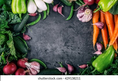 Assortment of fresh vegetables. Carrot garlic peas cabbage onion celery cucumber parsnip and radish concrete board. - Powered by Shutterstock