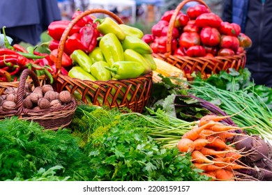 Assortment of fresh vegetables in the store. Carrots, tomatoes, peppers, onions, nuts, greens, on the table. - Shutterstock ID 2208159157