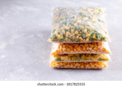 Assortment of frozen vegetables in a plastic bag on the table, copy space