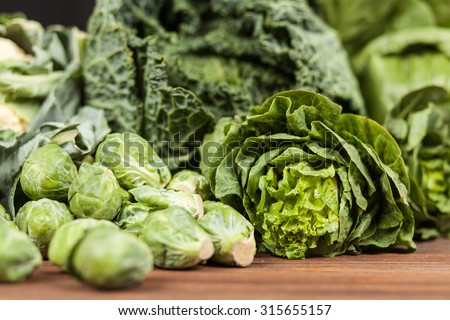 Assortment of green vegetables on wooden surface