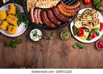 Assortment Of Grilled Sausages, Meat, And Vegetables. Picnic Barbeque Concept