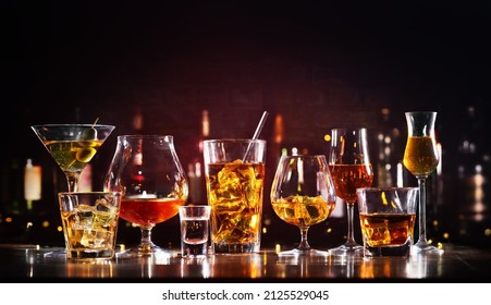 Assortment of hard strong alcoholic drinks and spirits in glasses on bar counter - Shutterstock ID 2125529045