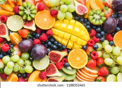 Assortment of healthy raw fruits and berries platter background, strawberries raspberries oranges plums apples kiwis grapes blueberries, mango, top view, selective focus - Powered by Shutterstock