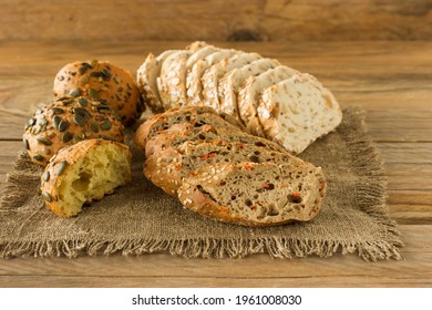 Assortment of Homemade Gluten-free vegan bread on the rustic wooden table. Homemade baked pastry. - Shutterstock ID 1961008030