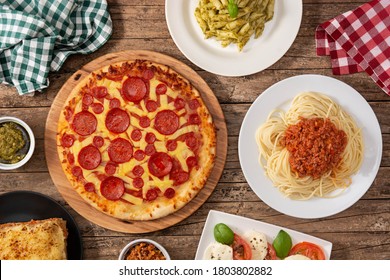 Assortment of Italian pasta dishes on wooden background.Top view - Powered by Shutterstock