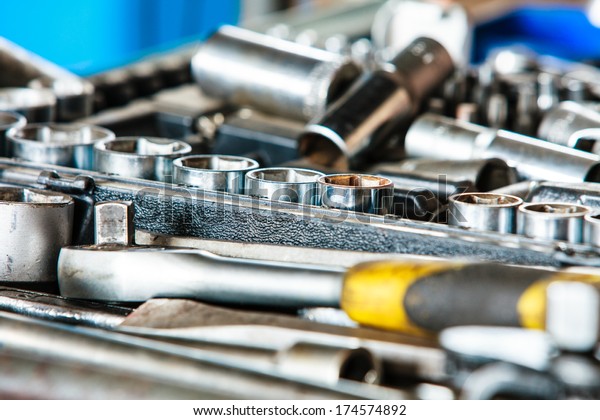 Assortment kit of adjustable metallic tools in\
mechanic garage car\
service