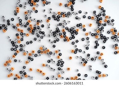 An assortment of letters and number scattered randomly across a black background, creating a dynamic and abstract composition; letter and number background