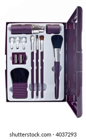 Assortment of makeup over a white background. Shallow DOF
