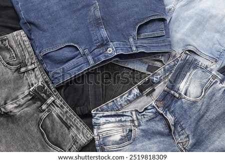 Assortment of many different fashionable jeans pants