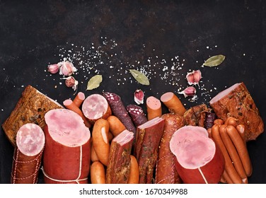 assortment of meat products including sausage ham bacon spices garlic on a black background view from the top. Boiled Ham Meatworks Product Photo