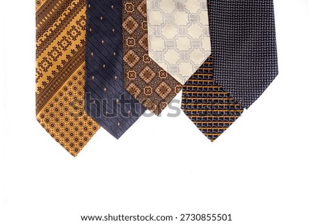 Assortment of men's neckties with different patterns isolated on a white background. Fashion accessories arranged diagonally with ample copy space for design.