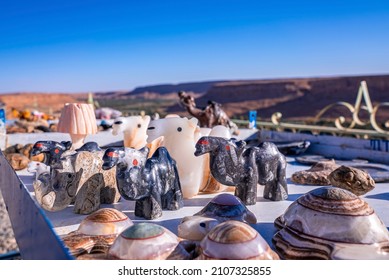 Assortment of multicolored marble figures of animals on display for sale at market, Various figurines of animals for sale
