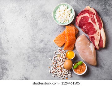 Assortment Of Natural Sources Of Protein From Food: Meat, Fish, Chicken, Dairy Products, Eggs, Beans. Diet, Healthy Eating, Wellness, Bodybuilding Concept, Top View, Space For Text
