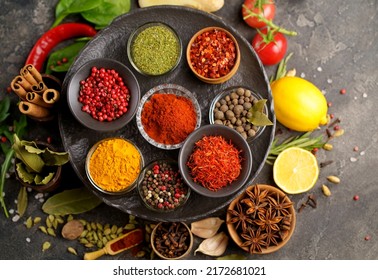 Assortment Of Natural Spices On Dark Rustic Stone Background, Healthy Spice Concept