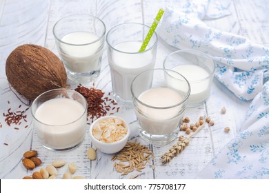 Assortment of non dairy vegan milk and ingredients on white wooden background. Healthy drinks concept. Copy space - Shutterstock ID 775708177