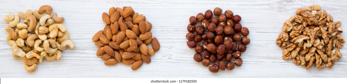 Assortment Of Nuts (cashew, Hazelnuts, Walnuts, Almonds) On White Wooden Surface. Top View, Overhead, From Above.