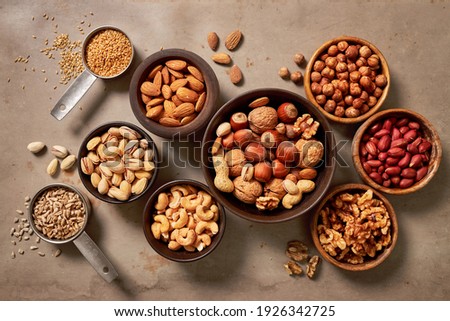 Assortment of nuts and seed on rustic table. Walnuts, cashew, almond, pistachio, hazelnut and peanut mix selection. 