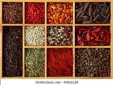 Assortment of peppercorns and chili in wooden box - Powered by Shutterstock