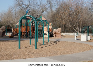 An Assortment Of Playground Equipment On Beds Of Tree Mulch